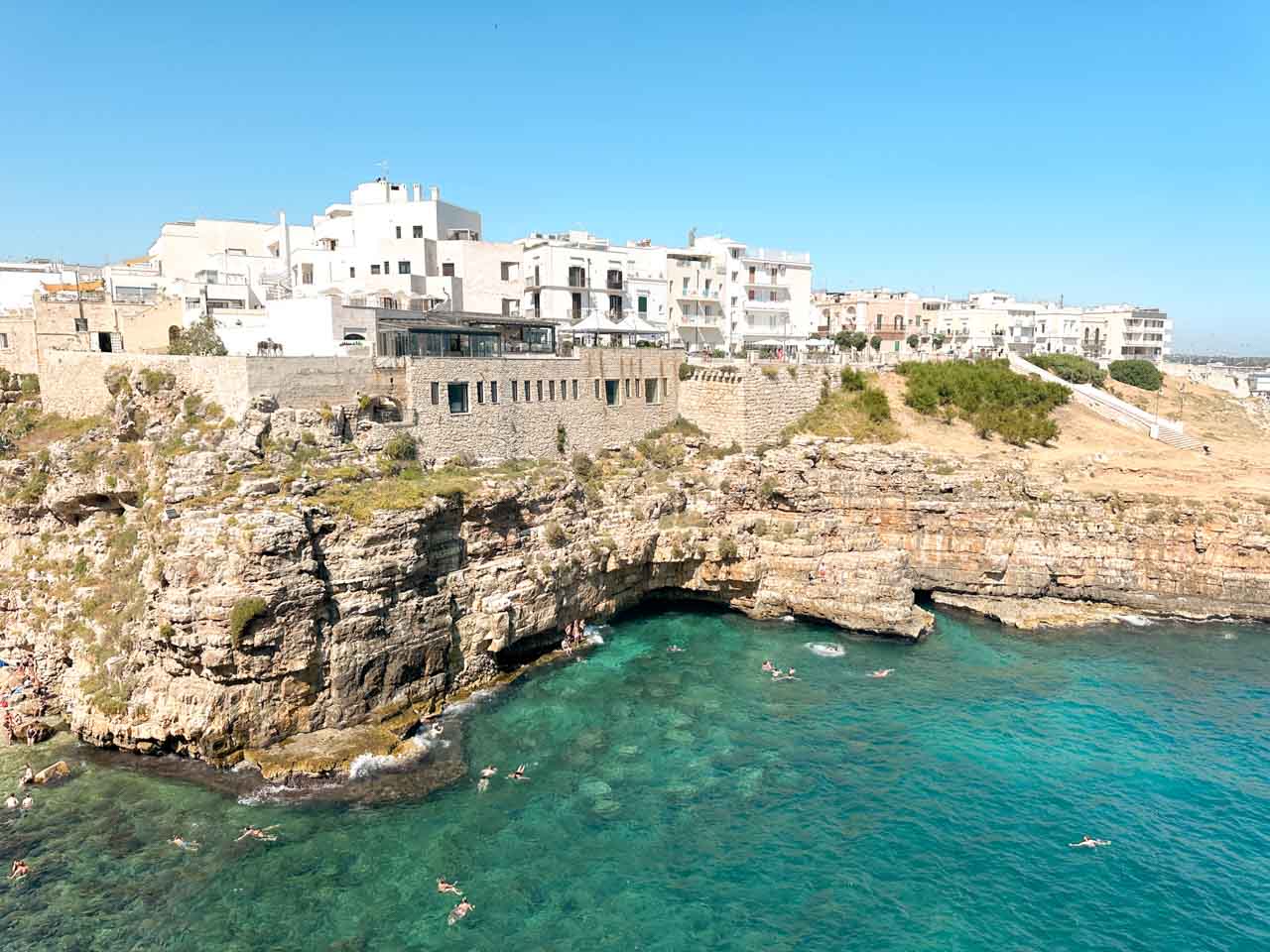 View over the cliffs and turquoise sea near Lama Monachile in Polignano a Mare, Italy