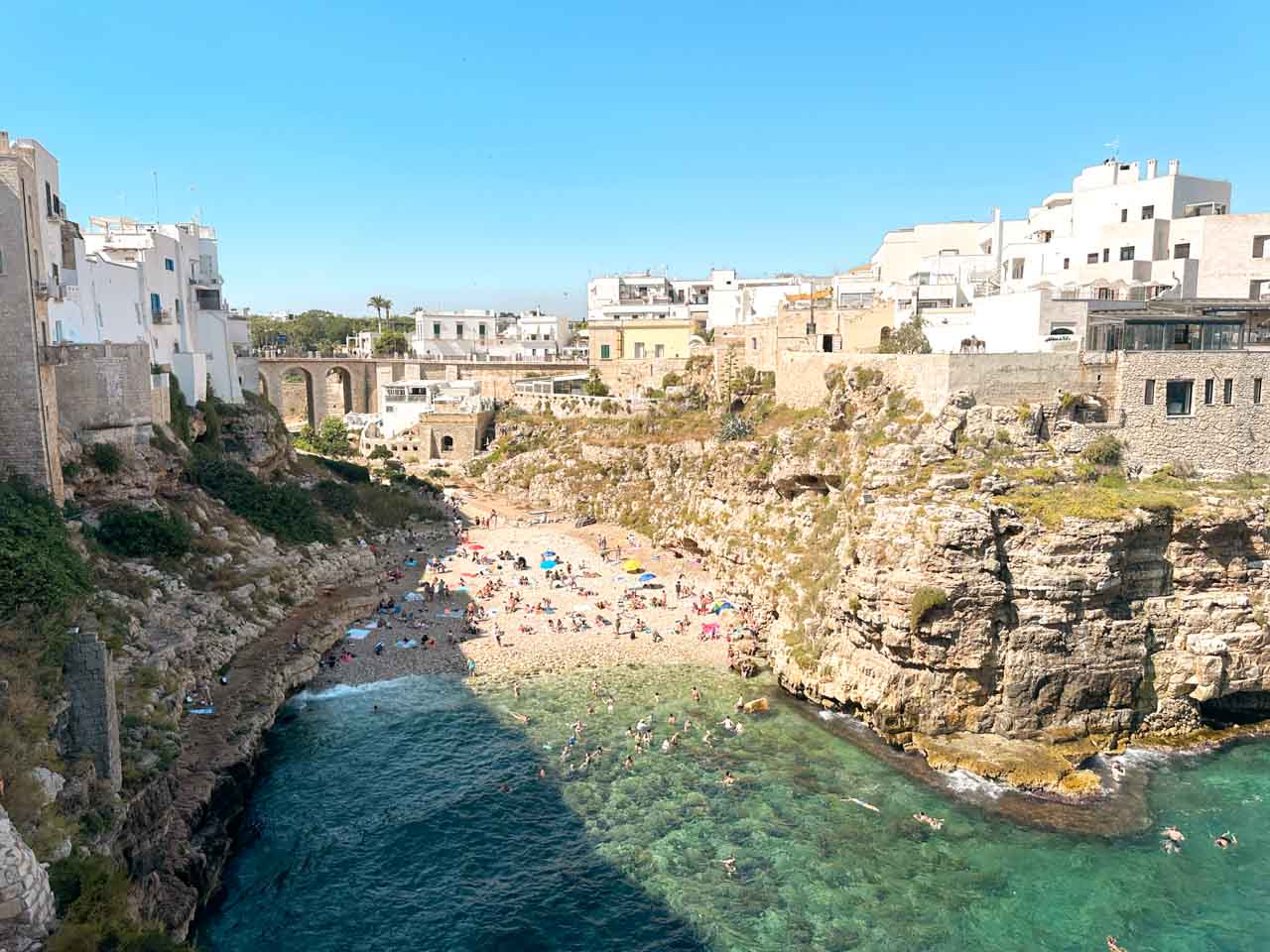 A view from above of the Lama Monachile beach and the cliffs in Polignano a Mare