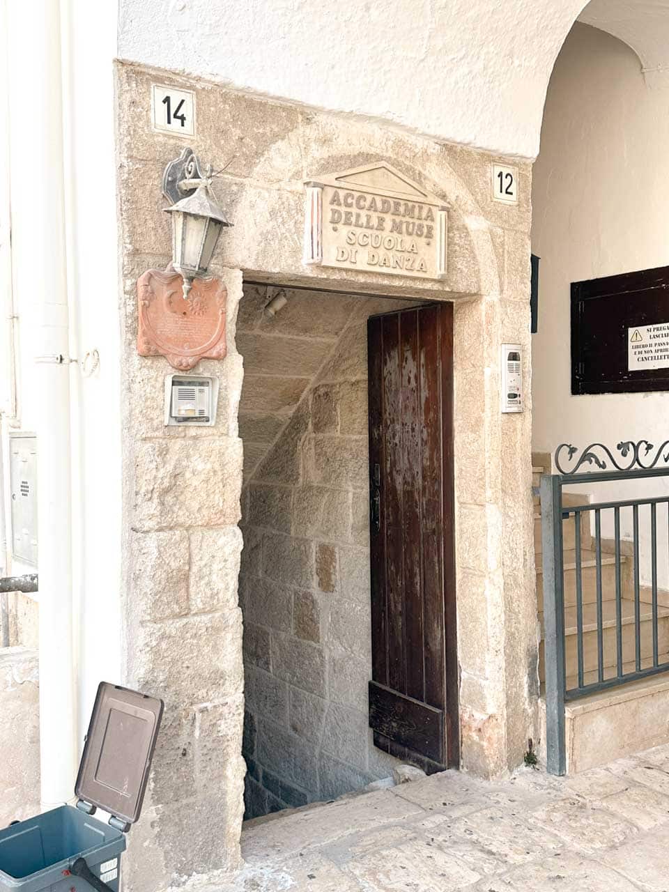 Stone doorway with a sign for Accademia delle Muse dance school in Polignano a Mare