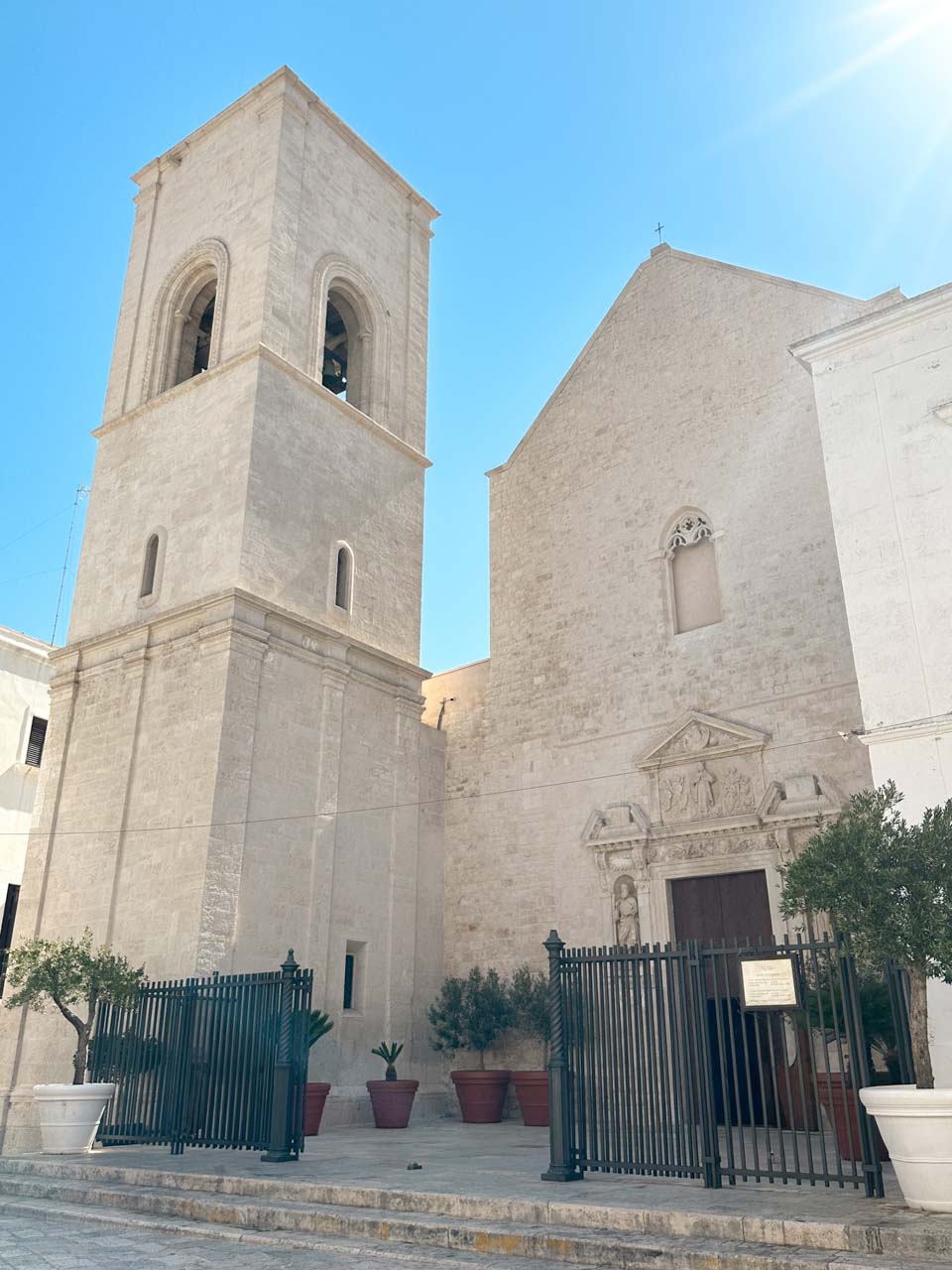 Church of Saint Mary of the Assumption in Polignano a Mare with a bell tower and a simple stone fa&ccedil;ade
