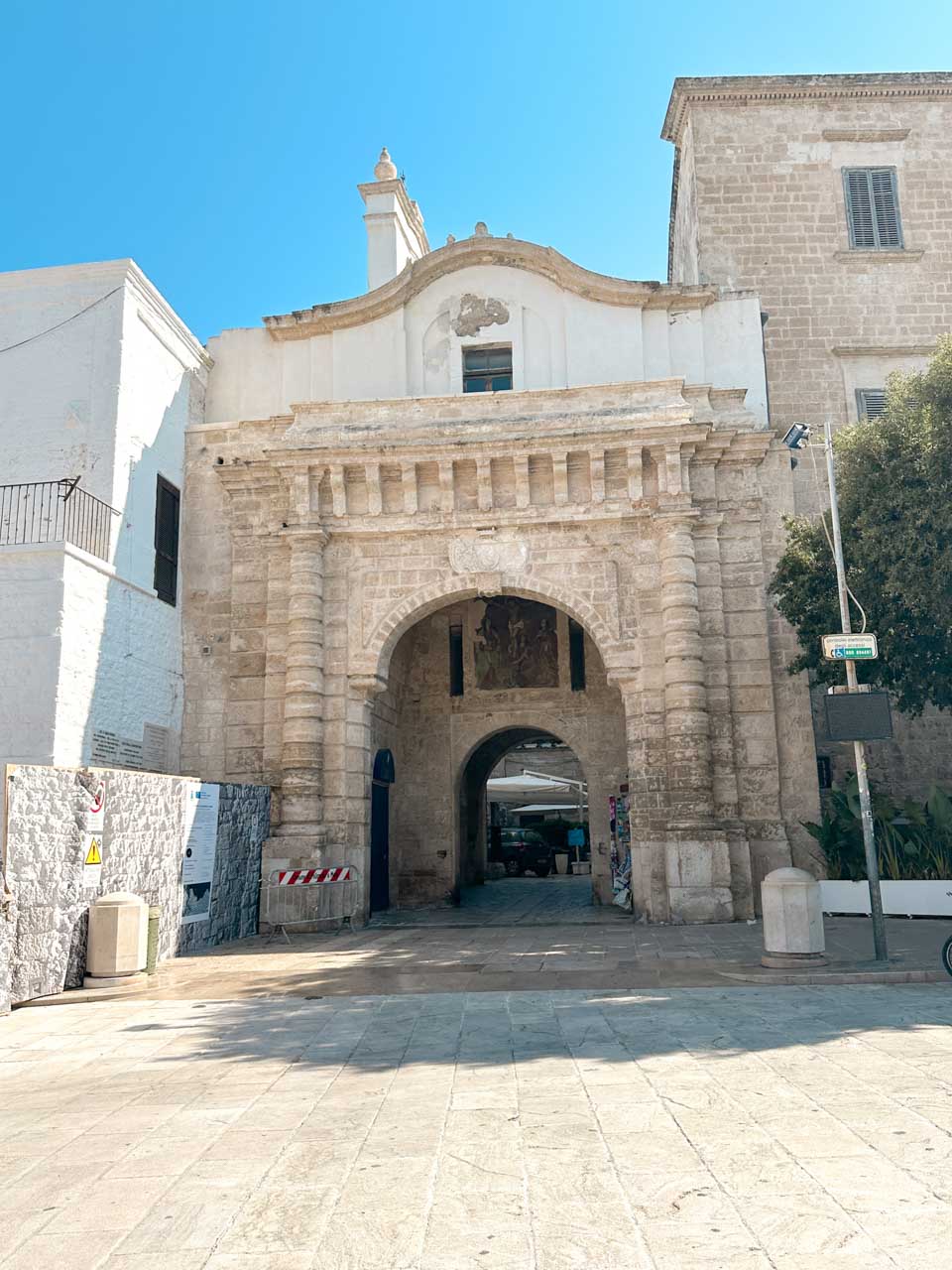 Historic stone archway entrance to the old town in Polignano a Mare
