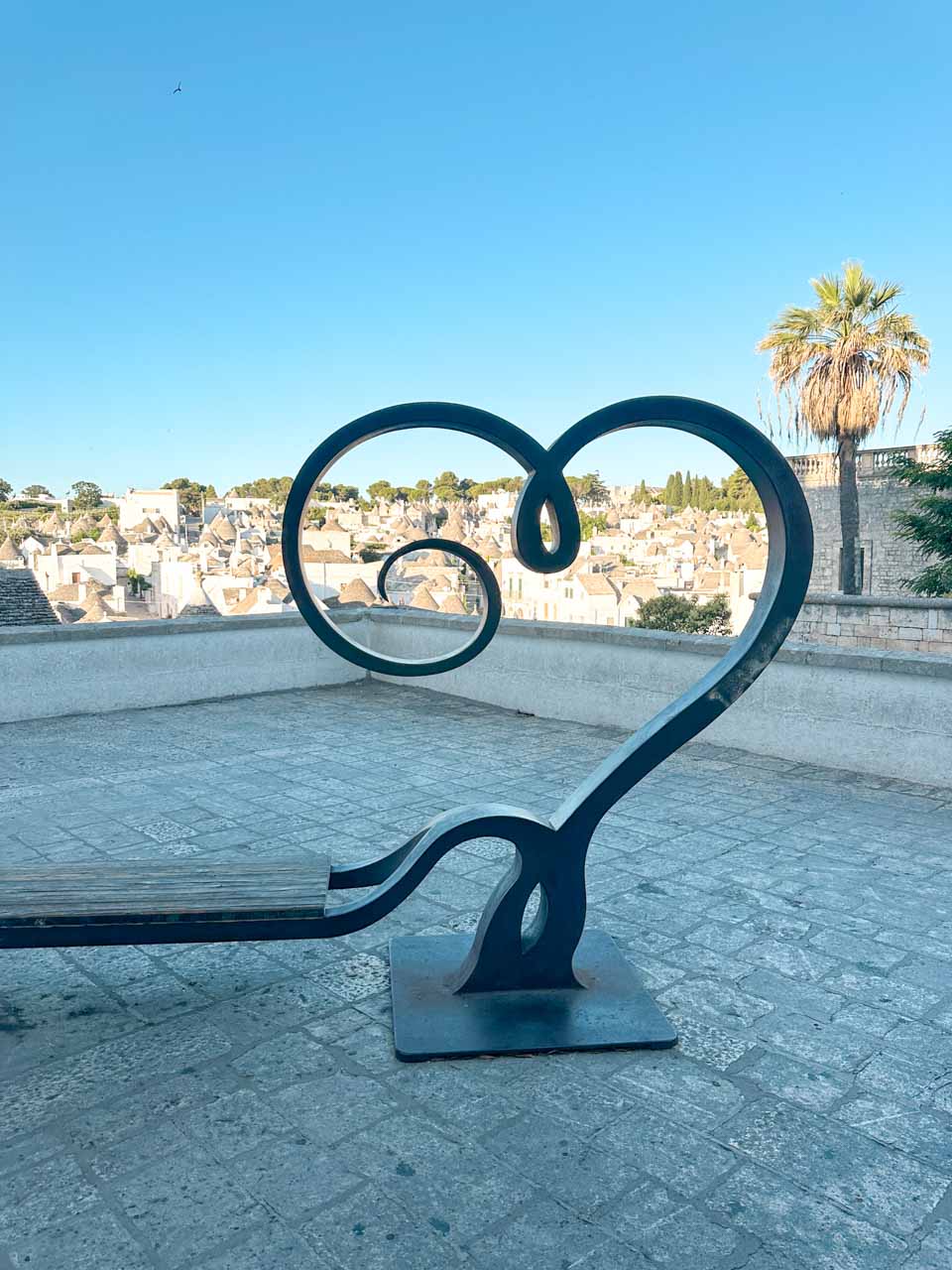 View of trulli rooftops through a heart-shaped frame in Alberobello, Italy