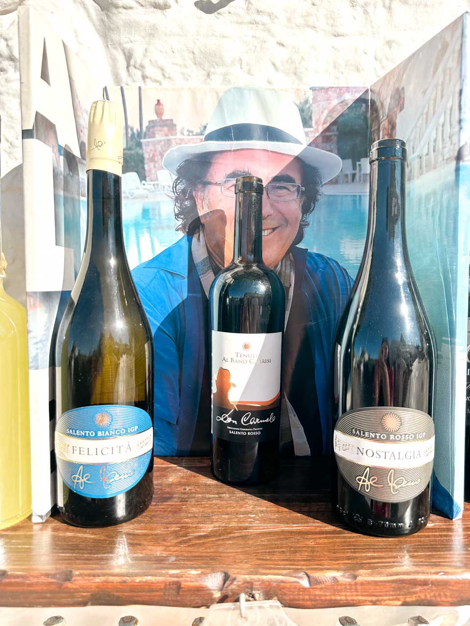 Wine bottles on display with a photo of Al Bano in a local shop in Alberobello, Italy