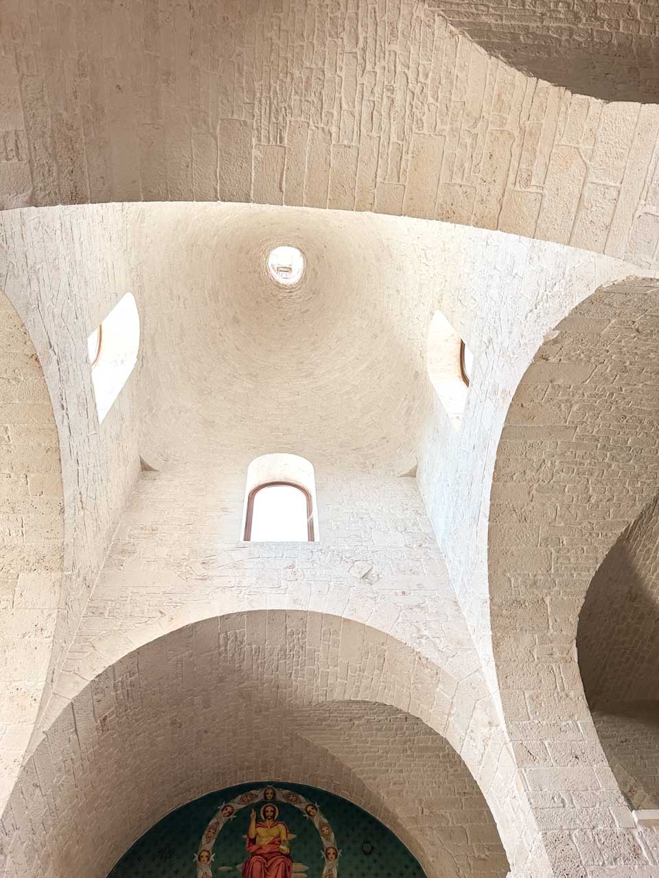 Stone vaulted ceiling with small windows inside the Church of Saint Anthony in Alberobello, Italy
