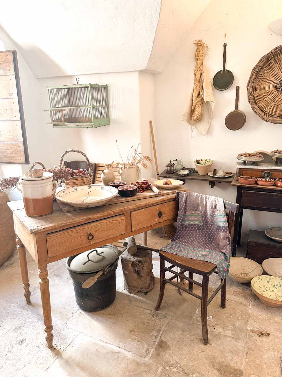 Historic kitchen display inside a traditional trullo house museum in Alberobello