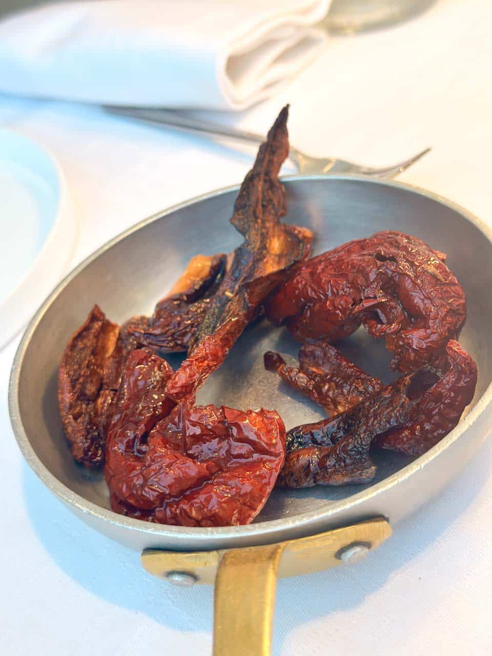 Crispy red peppers (peperoni cruschi) served in a small metal pan at San Biagio Ristorante in Matera, Italy