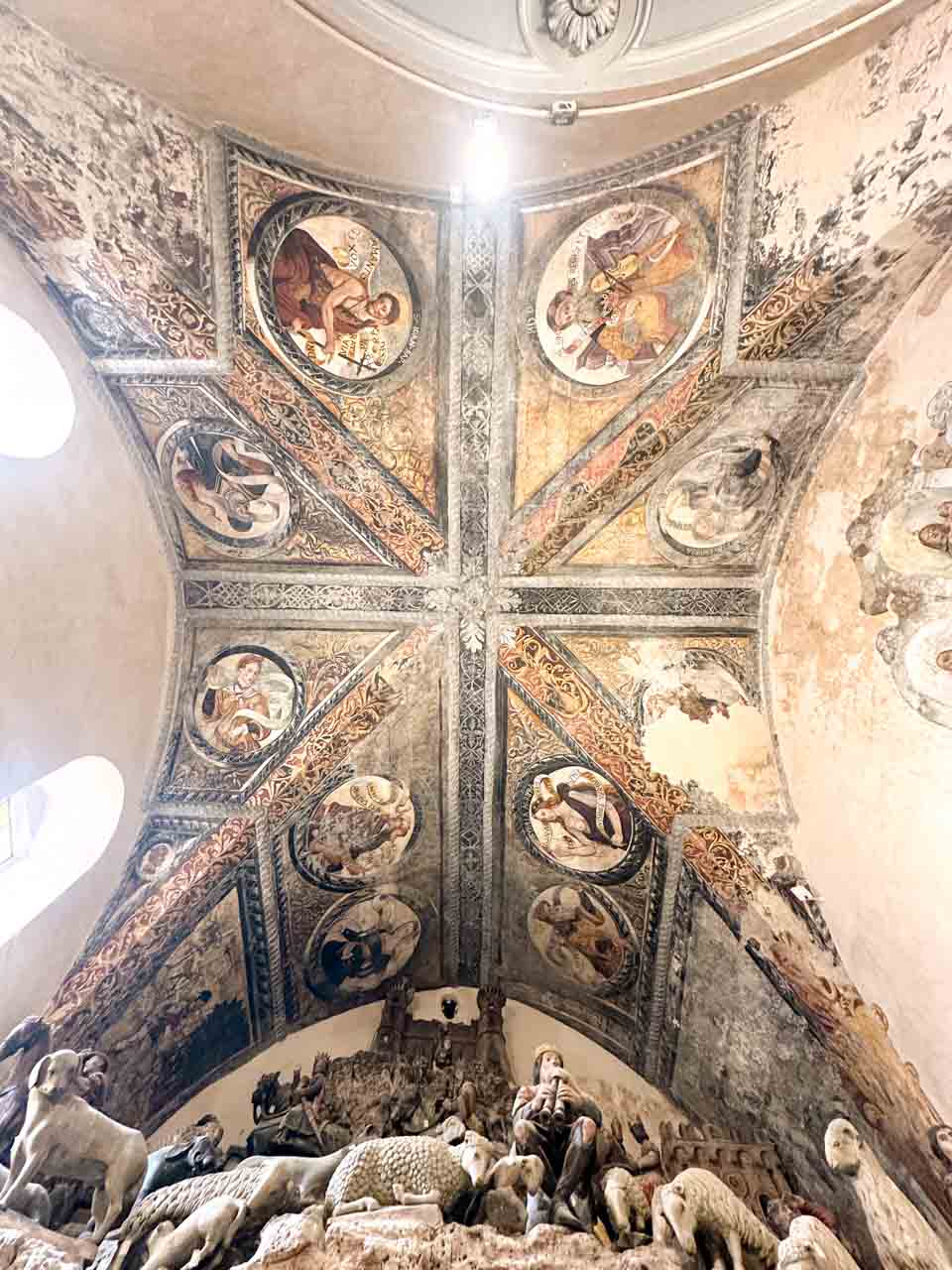 The painted ceiling and nativity scene inside Matera Cathedral