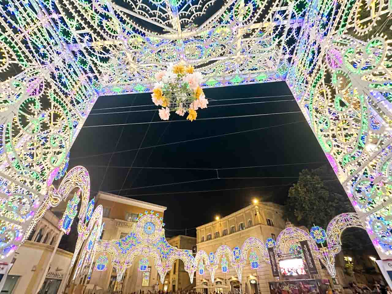 Colourful festival light displays and illuminated arches in Piazza Vittorio Veneto in Matera at night
