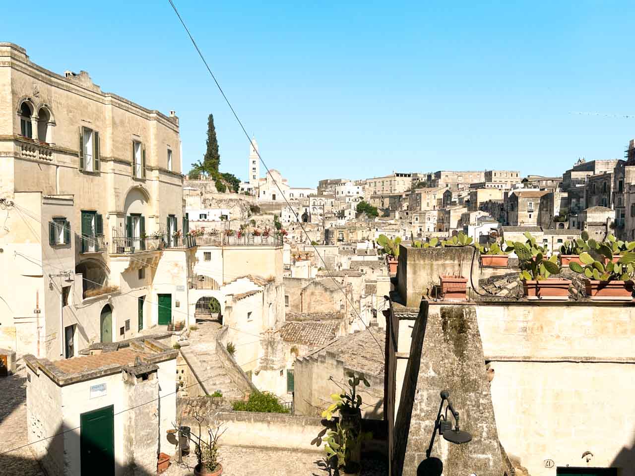 A wider view of the Sassi di Matera and the Cathedral of Matera from the Belvedere dei Tre Archi viewpoint in Piazza Vittorio Veneto