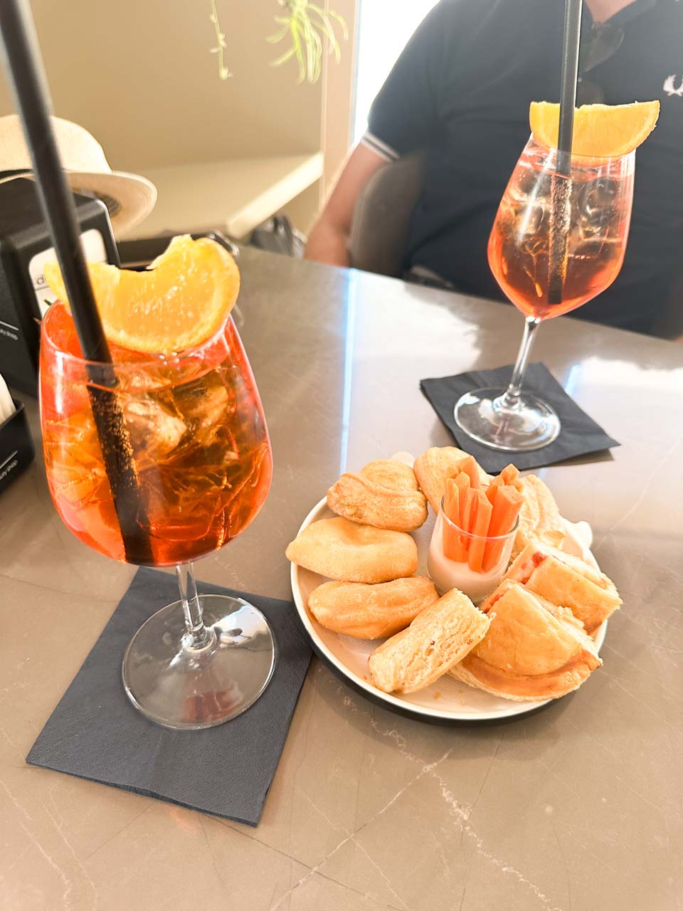 Two Aperol Spritz cocktails served with savoury snacks at Di Bitonto caf&eacute; in Matera