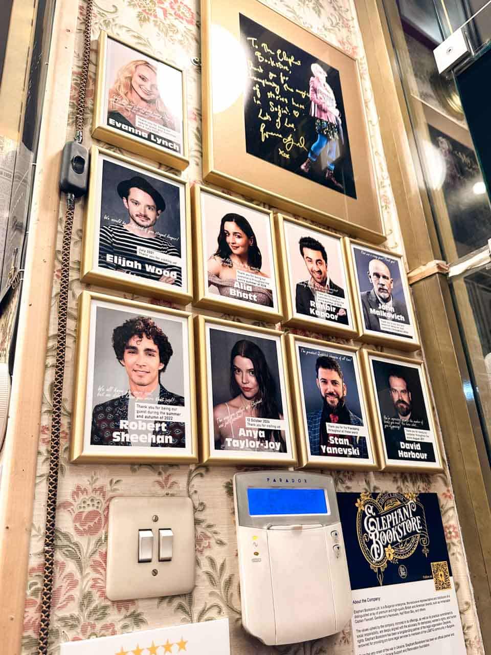 Wall of signed celebrity photos inside Elephant Bookstore in Sofia