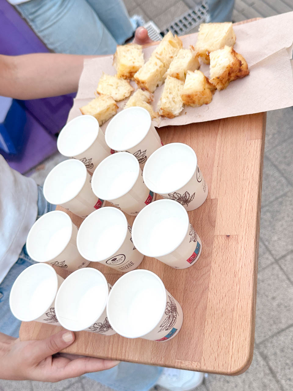 A tray of paper cups and pieces of traditional Bulgarian banitsa being handed out during a food tasting in Sofia