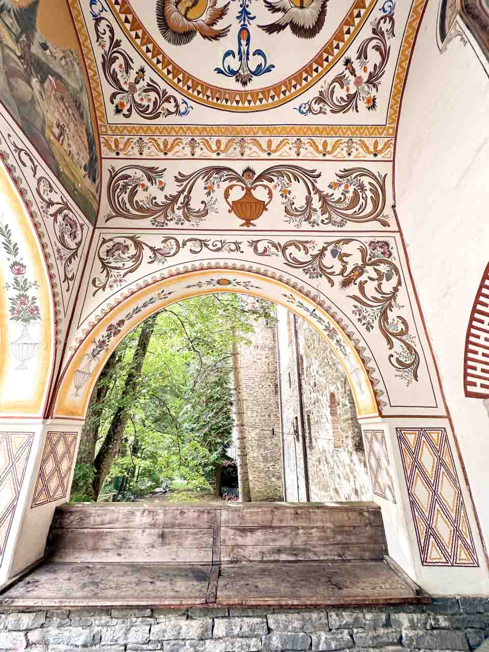 Decorated archway at Rila Monastery with colourful floral and bird patterns
