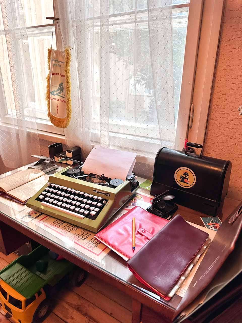 Retro Bulgarian typewriter and office supplies on a desk at the Red Flat museum in Sofia