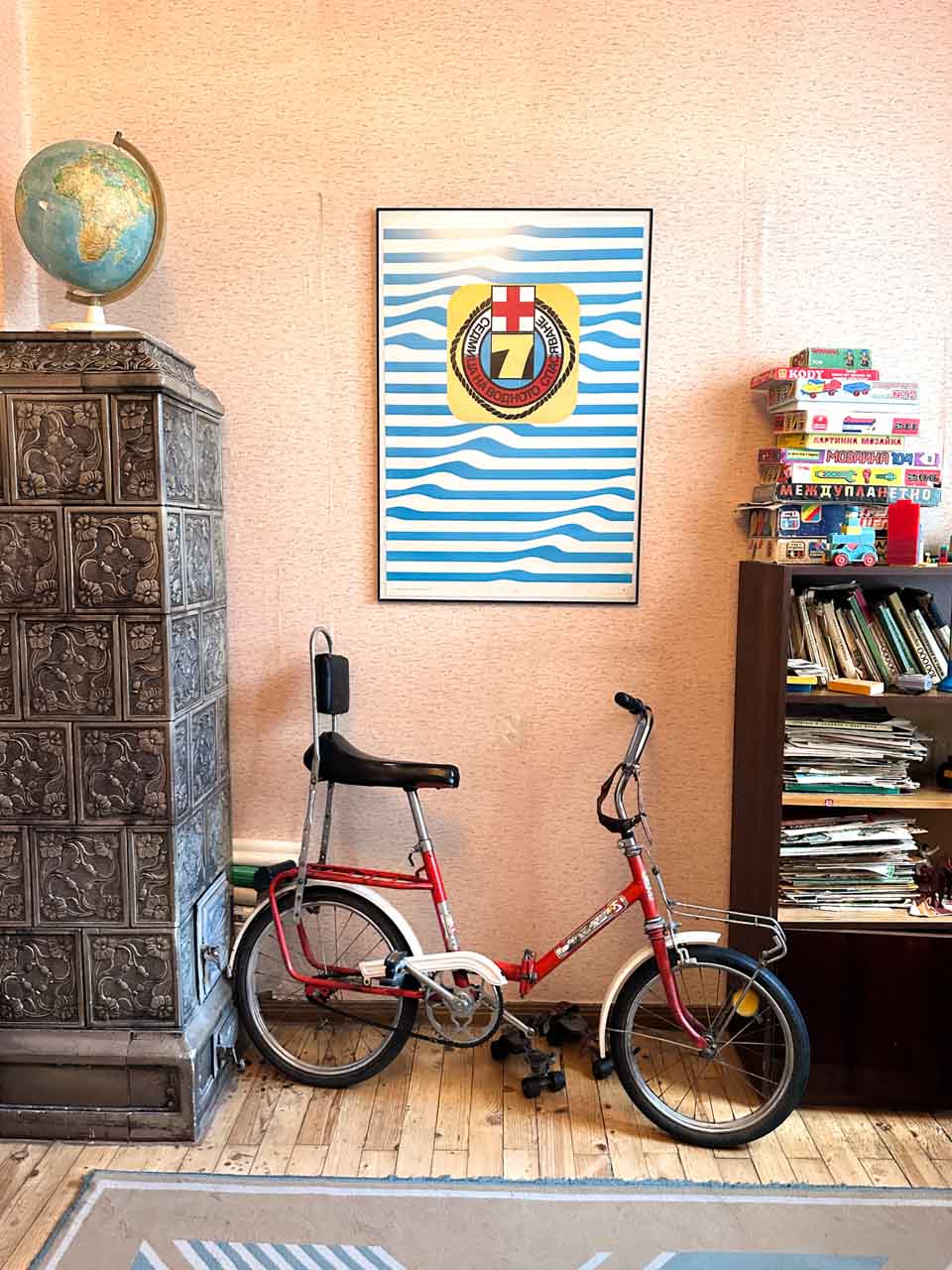 Retro red folding bicycle displayed in a bedroom at the Red Flat museum in Sofia, Bulgaria