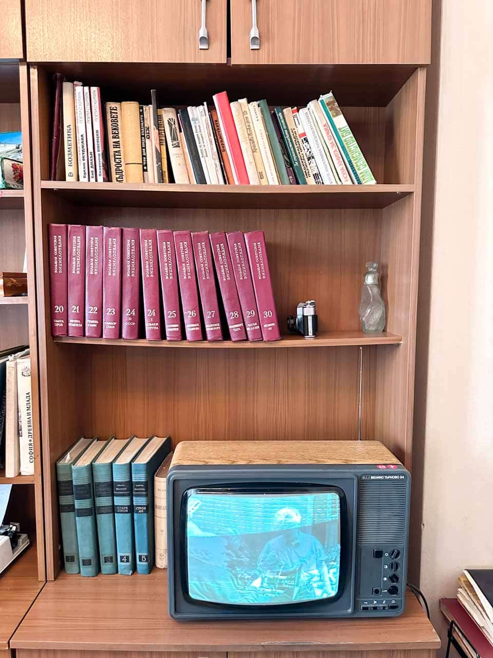 Vintage books and old television displayed on a bookcase at the Red Flat museum in Sofia, Bulgaria