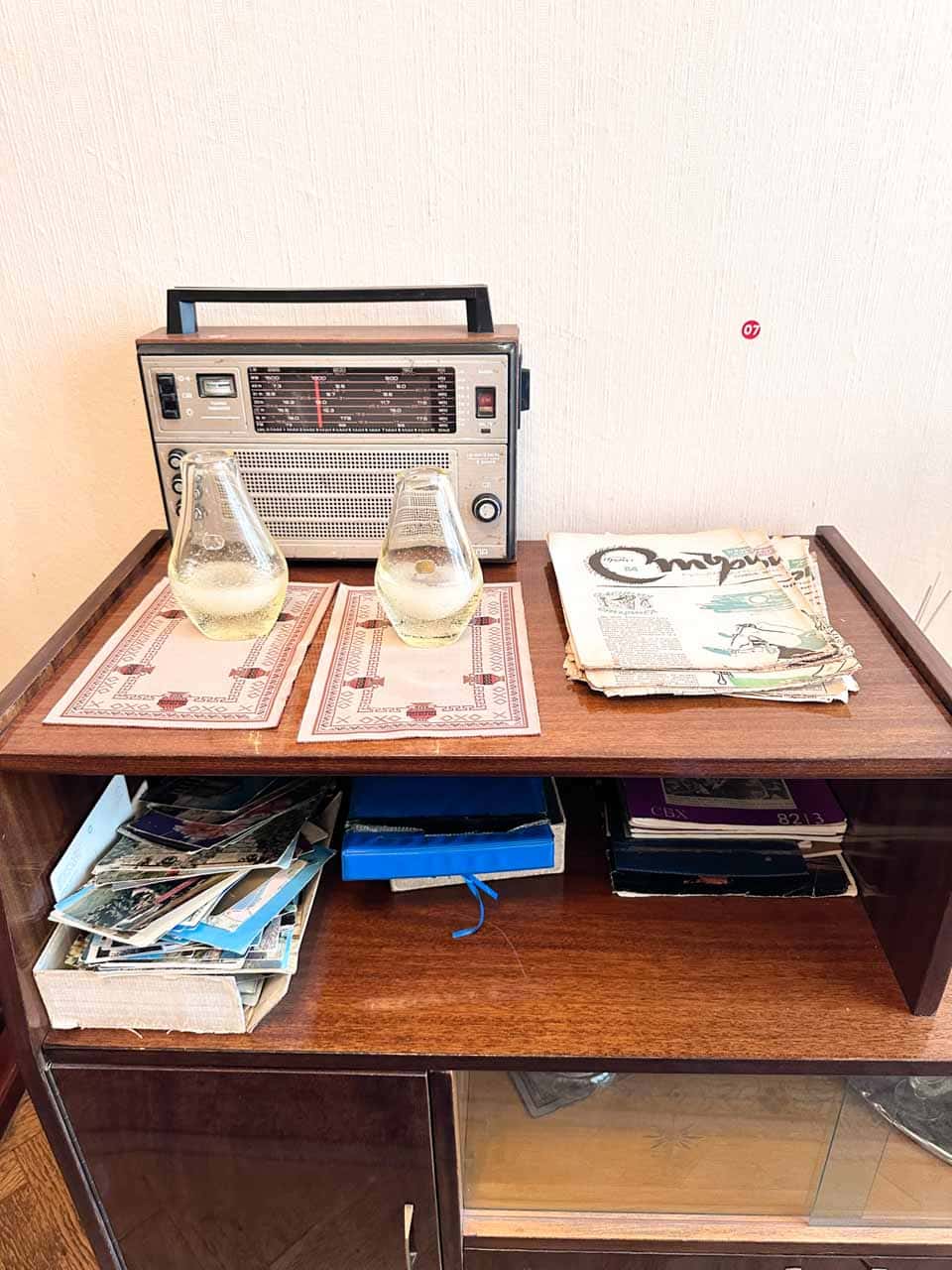 Vintage radio, drinking glasses, and magazines displayed at the Red Flat museum in Sofia