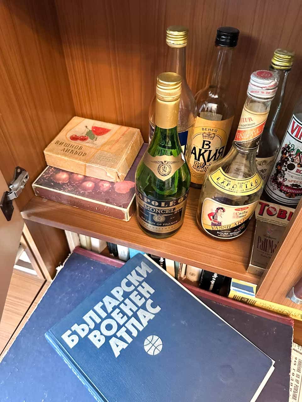 Vintage bottles and Bulgarian books displayed at the Red Flat museum in Sofia