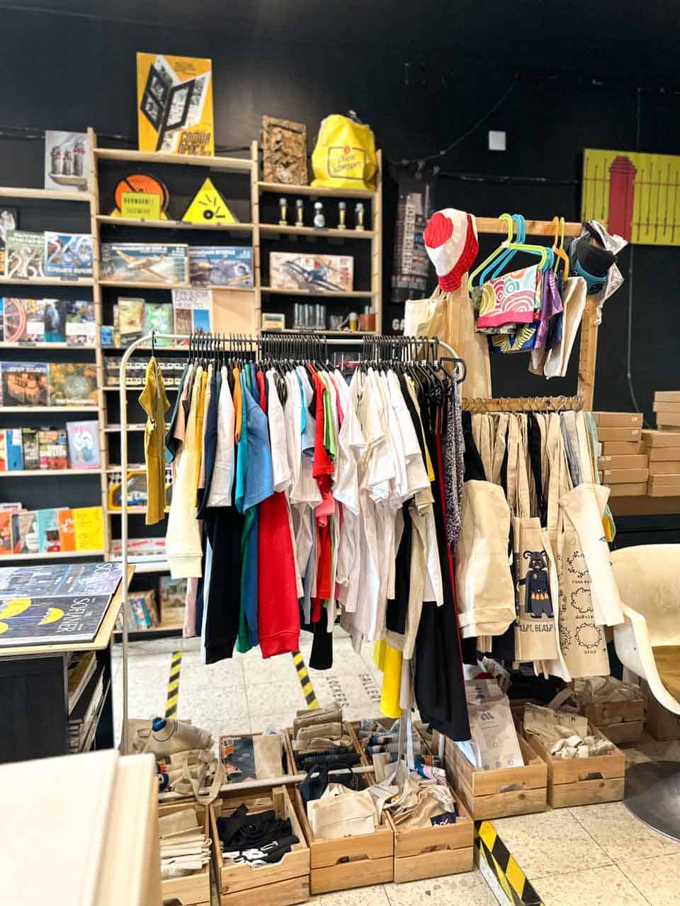 Clothing, tote bags, and souvenirs displayed inside the Gifted souvenir shop in Sofia
