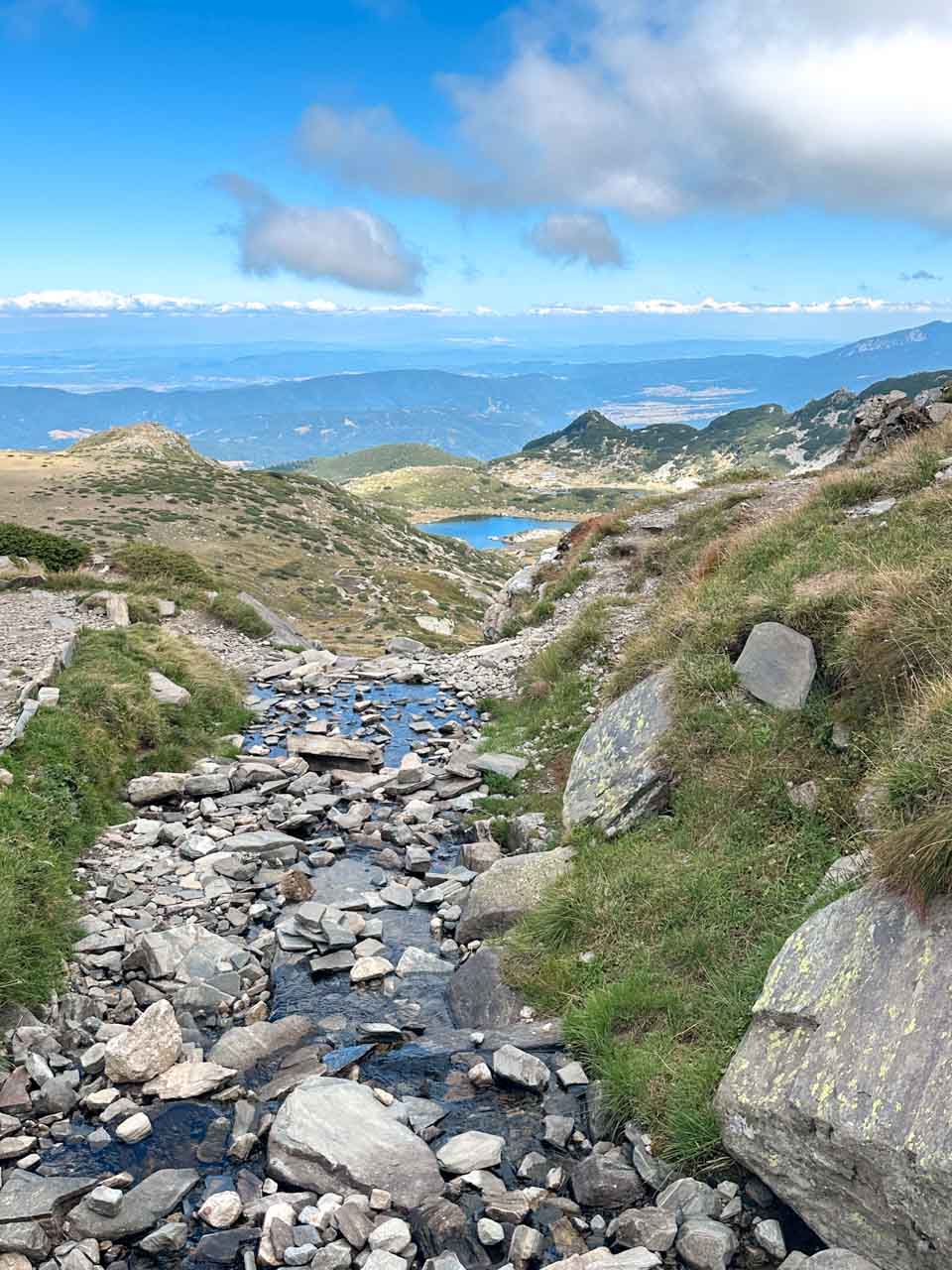Mountain stream flowing down a rocky slope towards one of the Seven Rila Lakes in Bulgaria&rsquo;s Rila Mountains