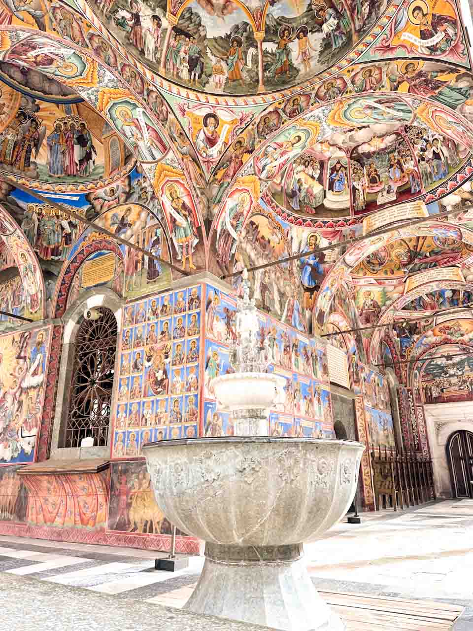 Colourful Orthodox frescoes covering the walls and vaulted ceilings at Rila Monastery in Bulgaria