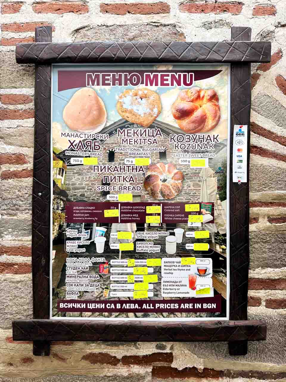 Menu displaying traditional Bulgarian bread, mekitsa, yoghurt, and drinks at Rila Monastery