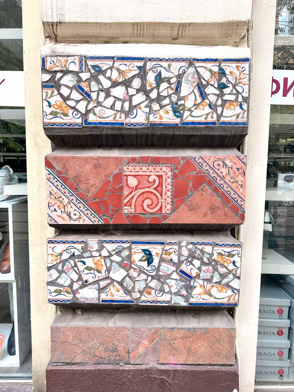 Decorative mosaic tiles with colourful floral patterns covering part of a building facade in central Sofia