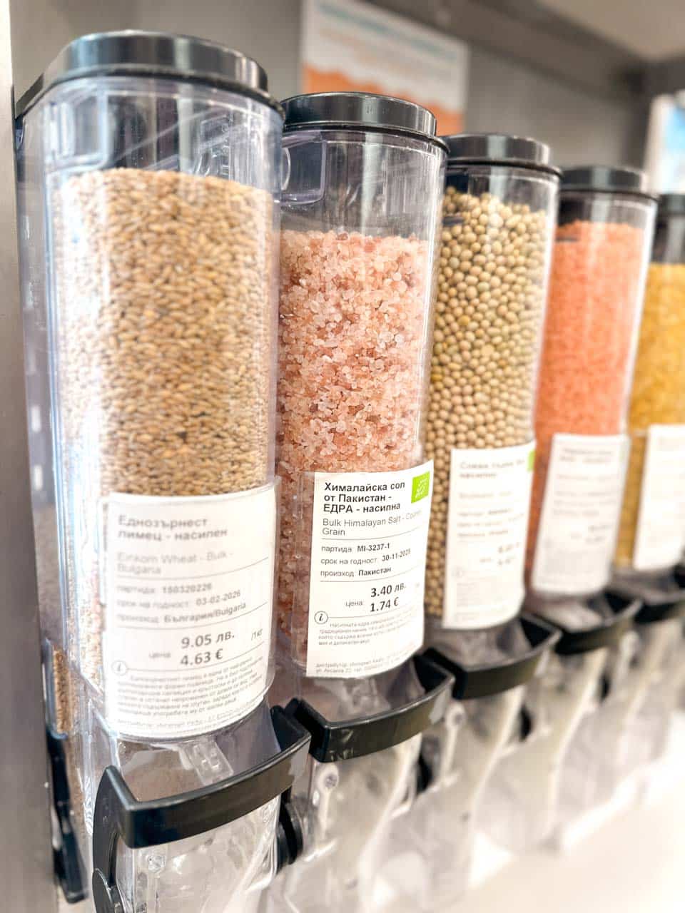 Bulk food dispensers filled with grains, Himalayan salt, and other ingredients at Zoya in Sofia