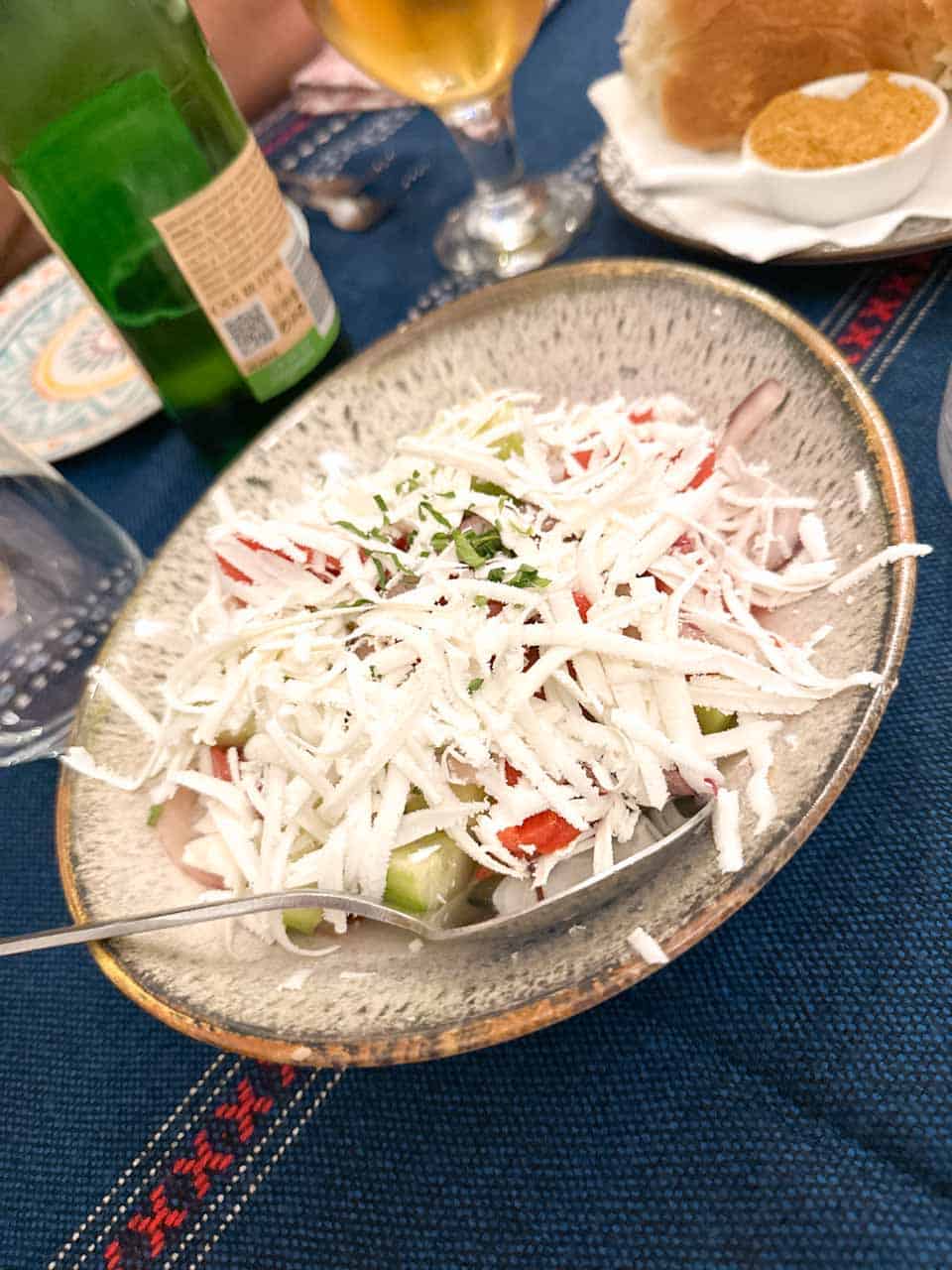 Shopska salad topped with grated Bulgarian cheese at Manastirska Magernitsa in Sofia, Bulgaria