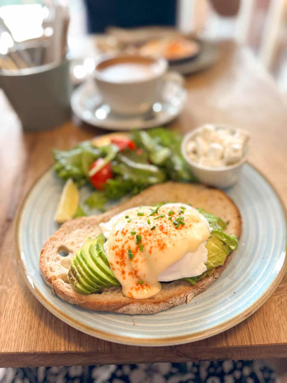 Avocado toast with poached eggs and hollandaise sauce at Izzy's Coffee and Brunch in Sofia, Bulgaria